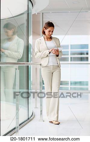Businesswoman using digital tablet View Large Photo Image Stock Image - Businesswoman using digital tablet. Fotosearch