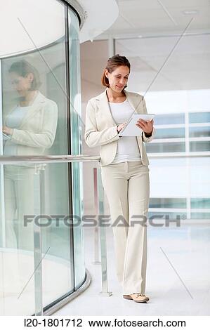 Businesswoman using digital tablet View Large Photo Image Stock Image - Businesswoman using digital tablet. Fotosearch