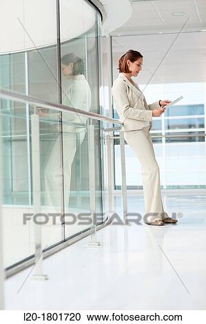 Stock Image - Businesswoman using digital tablet. Fotosearch