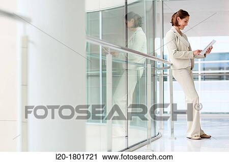 Businesswoman using digital tablet View Large Photo Image Stock Image - Businesswoman using digital tablet. Fotosearch