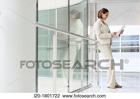 Stock Image - Businesswoman using digital tablet. Fotosearch