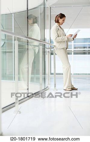 Businesswoman using digital tablet View Large Photo Image Stock Photo - Businesswoman using digital tablet. Fotosearch