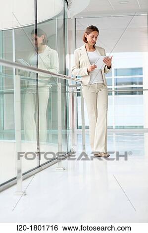 Stock Photograph - Businesswoman using digital tablet. Fotosearch