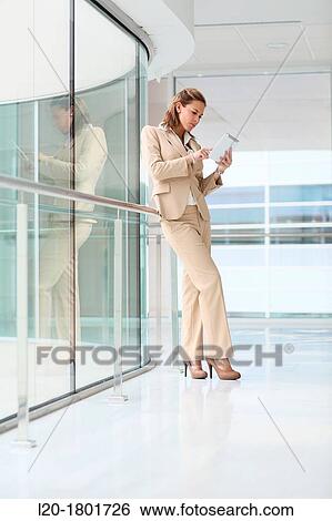 Businesswoman using digital tablet View Large Photo Image Stock Photograph - Businesswoman using digital tablet. Fotosearch