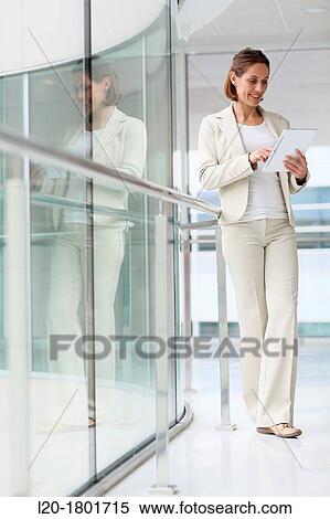 Businesswoman using digital tablet View Large Photo Image Stock Photography - Businesswoman using digital tablet. Fotosearch