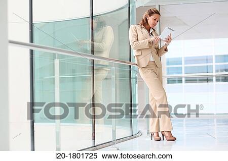 Businesswoman using digital tablet View Large Photo Image Stock Photography - Businesswoman using digital tablet. Fotosearch