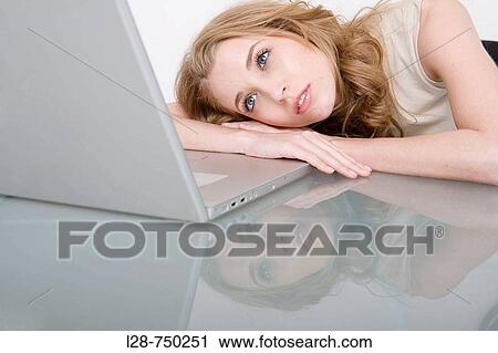 Businesswoman using laptop at desk View Large Photo Image Stock Image - Businesswoman using laptop at desk. Fotosearch
