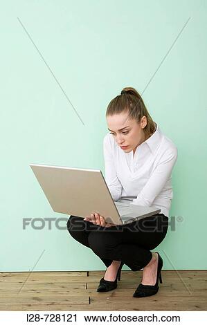 Stock Image - Businesswoman using laptop,. Fotosearch