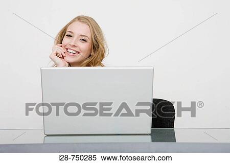 Stock Photography - businesswoman using laptop. Fotosearch