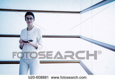 Stock Image - Businesswoman with pocket computer. Fotosearch