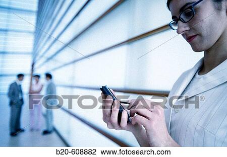 Stock Image - Businesswoman with pocket computer. Fotosearch