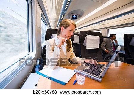 Businesswoman working connected to the internet. Passenger. AVE, Tren de Alta Velocidad, Zaragoza, Arag? n. Spain. View Large Photo Image Stock Photo - Businesswoman working connected to the internet. Passenger. AVE, Tren de Alta Velocidad, Zaragoza, Arag? n. Spain.. Fotosearch