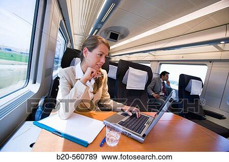 Businesswoman working connected to the internet. Passenger. AVE, Tren de Alta Velocidad, Zaragoza, Arag? n. Spain. View Large Photo Image Stock Photo - Businesswoman working connected to the internet. Passenger. AVE, Tren de Alta Velocidad, Zaragoza, Arag? n. Spain.. Fotosearch