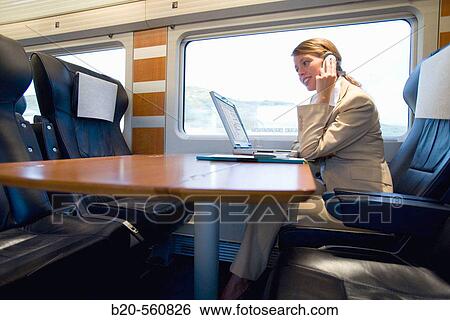 Businesswoman working connected to the internet. Passenger. AVE, Tren de Alta Velocidad, Zaragoza, Arag? n. Spain. View Large Photo Image Stock Photograph - Businesswoman working connected to the internet. Passenger. AVE, Tren de Alta Velocidad, Zaragoza, Arag? n. Spain.. Fotosearch