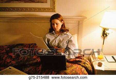 Stock Photo - Businesswoman working in Hotel Room. Fotosearch