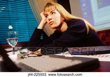Businesswoman working on a desk with laptop computer in an office View Large Photo Image Stock Image - Businesswoman working on a desk with laptop computer in an office. Fotosearch