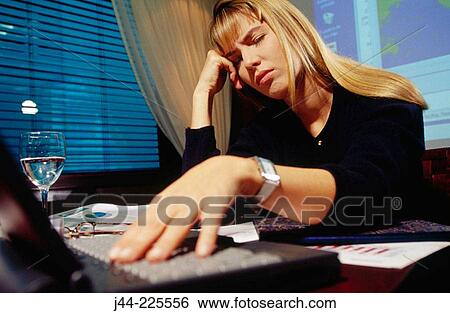 Businesswoman working on a desk with laptop computer in an office View Large Photo Image Stock Photograph - Businesswoman working on a desk with laptop computer in an office. Fotosearch
