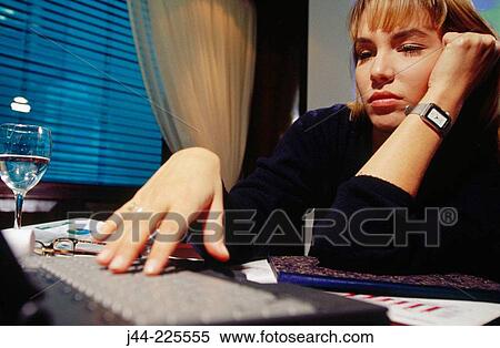 Businesswoman working on a desk with laptop computer in an office View Large Photo Image Stock Photography - Businesswoman working on a desk with laptop computer in an office. Fotosearch