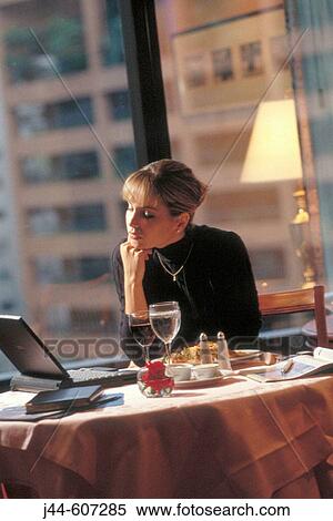Businesswoman working with lap top while having breakfast in a hotel room View Large Photo Image Stock Photography - Businesswoman working with lap top while having breakfast in a hotel room. Fotosearch