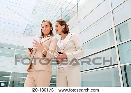 Stock Image - Businesswomen using digital tablet. Fotosearch