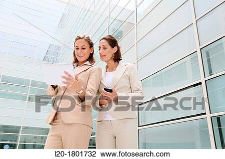 Businesswomen using digital tablet View Large Photo Image Stock Image - Businesswomen using digital tablet. Fotosearch