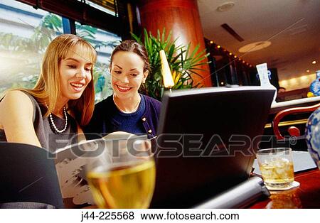 Businesswomen working in a hotel lounge View Large Photo Image Stock Photo - Businesswomen working in a hotel lounge. Fotosearch