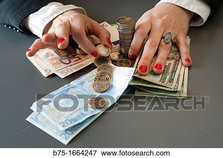 bussines, news paper, manos de mujer, manos contando, euros, moneda europea, moneda comunitaria, dinero, dolares, dolar usa, moneda, divisa, primer plano, valor, economia, cotizacion, mercado, compra venta, moneda extranjera View Large Photo Image Stock Photo - bussines, news paper, manos de mujer, manos contando, euros, moneda europea, moneda comunitaria, dinero, dolares, dolar usa, moneda, divisa, primer plano, valor, economia, cotizacion, mercado, compra venta, moneda extranjera. Fotosearch