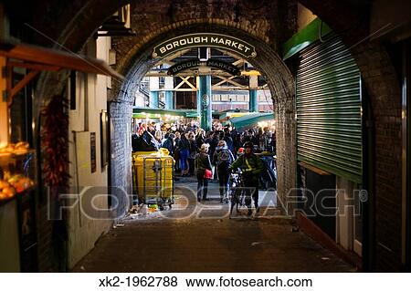 Stock Photo - Busy Borough Market from a tunnel, Borough Market, London, UK. Fotosearch