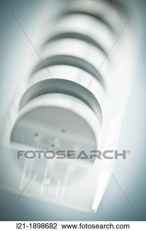 Button cells in row within a transparent plastic container. Batteries ready for recycling. View Large Photo Image Stock Image - Button cells in row within a transparent plastic container. Batteries ready for recycling.. Fotosearch