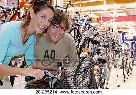 Picture - Buying a bicycle at shopping center. Fotosearch
