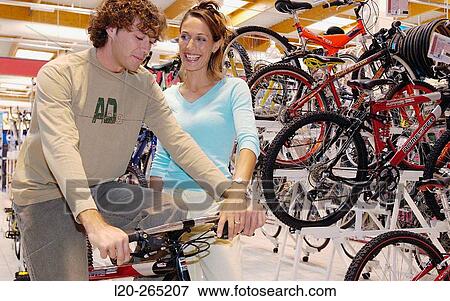 Buying a bicycle at shopping center View Large Photo Image Stock Photo - Buying a bicycle at shopping center. Fotosearch