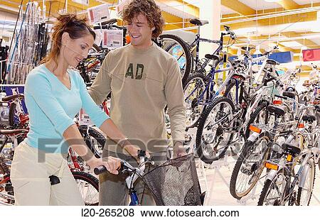 Buying a bicycle at shopping center View Large Photo Image Stock Photo - Buying a bicycle at shopping center. Fotosearch