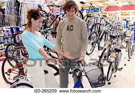 Buying a bicycle at shopping center View Large Photo Image Stock Photo - Buying a bicycle at shopping center. Fotosearch