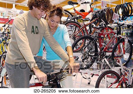 Buying a bicycle at shopping center View Large Photo Image Stock Photography - Buying a bicycle at shopping center. Fotosearch