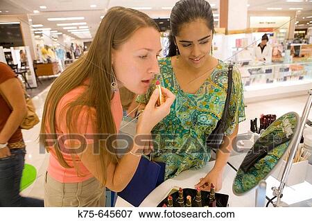 Buying lipstick. View Large Photo Image Stock Photo - Buying lipstick.. Fotosearch