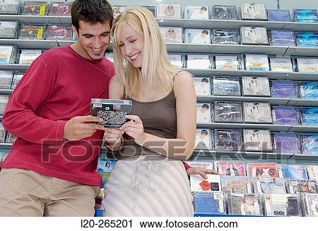 Buying music CD at shopping center View Large Photo Image Stock Image - Buying music CD at shopping center. Fotosearch
