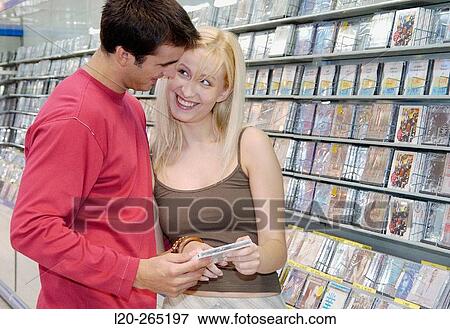 Stock Photo - Buying music CD at shopping center. Fotosearch