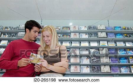 Stock Photo - Buying music CD at shopping center. Fotosearch