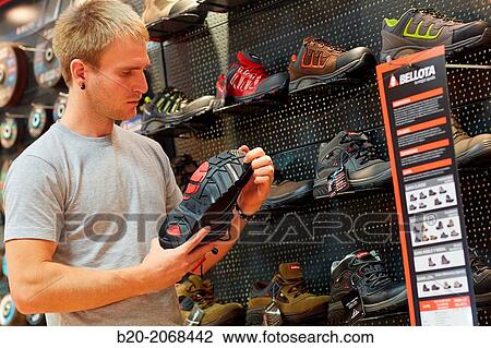 Buying protective boots. Hardware store. View Large Photo Image Stock Image - Buying protective boots. Hardware store.. Fotosearch