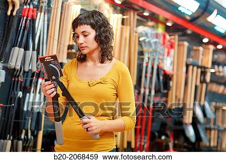 Buying pruning shears. Hand tools for agriculture and garden. Hardware store. View Large Photo Image Stock Photo - Buying pruning shears. Hand tools for agriculture and garden. Hardware store.. Fotosearch