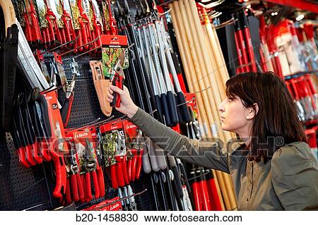 Buying tool in a hardware store, gardening tools View Large Photo Image Stock Image - Buying tool in a hardware store, gardening tools. Fotosearch
