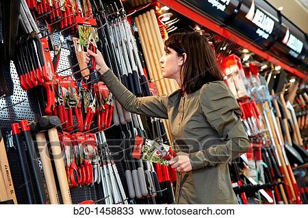 Buying tool in a hardware store, gardening tools View Large Photo Image Stock Image - Buying tool in a hardware store, gardening tools. Fotosearch