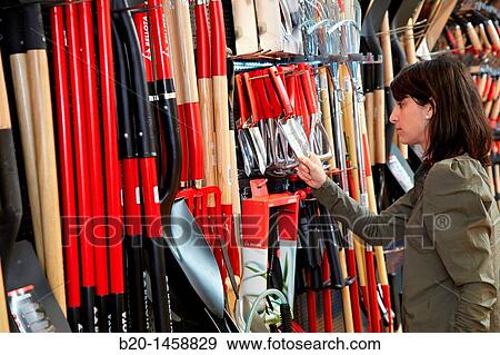 Buying tool in a hardware store, gardening tools View Large Photo Image Stock Photo - Buying tool in a hardware store, gardening tools. Fotosearch