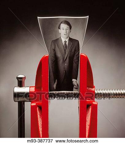 Stock Photo - B/W photo of business man; photo in red vise as though the man were being squeezed. Man looks distressed.. Fotosearch