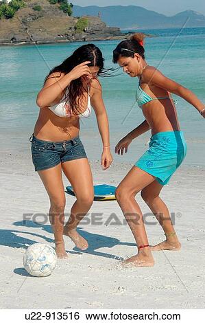 Stock Photograph - Cabo Frio (Rio de Janeiro, Brazil): girls playing soccer at Praia do Forte beach. Fotosearch