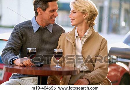 Stock Photography - cafe couple having a glass of wine. Fotosearch