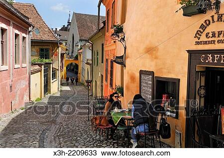 cafe terrace on Cositorarilor Street in the Old Town, Sighisoara, Transylvania, Romania, Southeastern and Central Europe. View Large Photo Image Stock Image - cafe terrace on Cositorarilor Street in the Old Town, Sighisoara, Transylvania, Romania, Southeastern and Central Europe.. Fotosearch