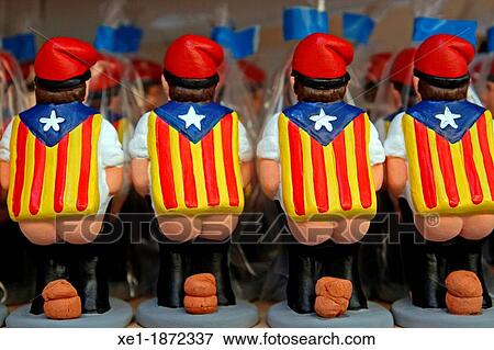 Stock Photo - caganers, nativity figures, Catalan flags. Fotosearch
