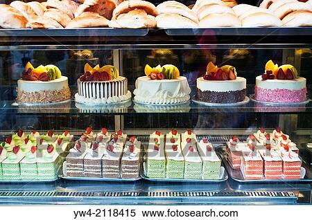 Stock Photography - Cakes in a window at Kowloon Restaurant and Bakery, Chinatown, Soho, London, WC2, UK.. Fotosearch