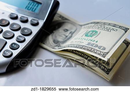 Calculator with American hundred dollar bills isolated on white View Large Photo Image Stock Photography - Calculator with American hundred dollar bills isolated on white. Fotosearch
